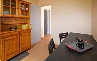 a dining room with a table and a wooden cabinet at Cozy Apartment In Piana in Piana