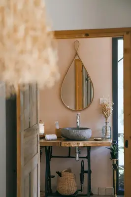 a bathroom with a sink and a mirror at LA PAUSE - 3 villas avec Jacuzzi privatif à chisà in Chisa