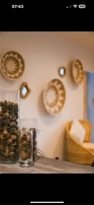 a table with a vase filled with nuts on a wall at LA PAUSE - 3 villas avec Jacuzzi privatif à chisà in Chisa