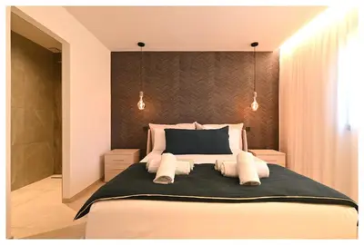 a bedroom with a large bed with two pillows at Villa neuve perchée - Vue splendide in Zonza
