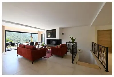 a living room with red chairs and a table at Villa neuve perchée - Vue splendide in Zonza