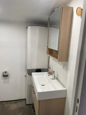 a bathroom with a white sink and a cabinet at Studio Ajaccio Centre in Ajaccio