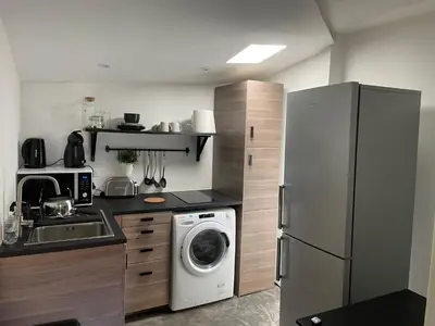 a kitchen with a refrigerator and a washing machine at Studio Ajaccio Centre in Ajaccio