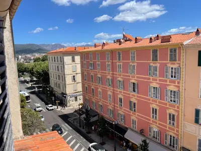 a pink building on a street in a city at Studio Ajaccio Centre in Ajaccio