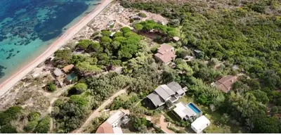 an aerial view of a house next to the ocean at Villa au bord de mer Bonifacio in Bonifacio
