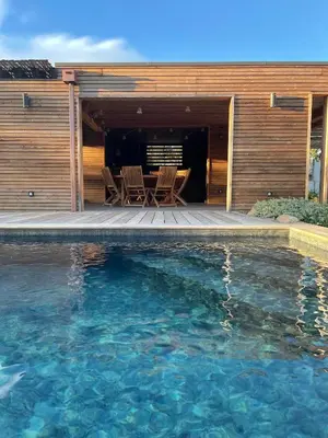 a swimming pool in front of a house at Villa au bord de mer Bonifacio in Bonifacio