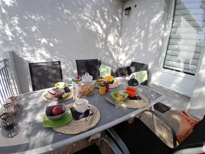 a table with a tray of food on it at La maison sous les oliviers Casa d'Iloa in Porto-Vecchio
