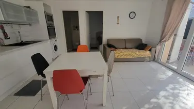 a kitchen and living room with a table and chairs at Escape and comfort near Ajaccio, beautiful 2 bedroom terrace in Alata