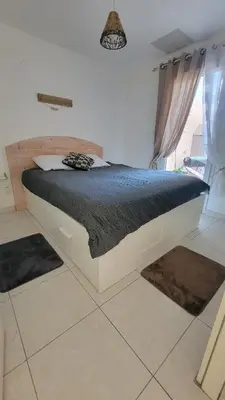 a bed in a room with rugs on the floor at Escape and comfort near Ajaccio, beautiful 2 bedroom terrace in Alata