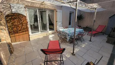 a patio with a table and chairs on a patio at Escape and comfort near Ajaccio, beautiful 2 bedroom terrace in Alata