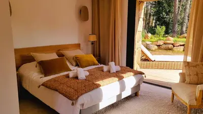 a bedroom with a bed and a large window at Domaine de Gialla Bergerie I Pini, 2 pers, piscine chauffée, 10 mn plage in Arraggio