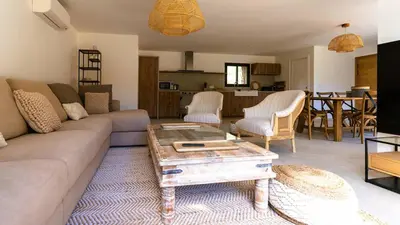a living room with a couch and a table at Domaine de Gialla Bergerie I Pini, 6 pers, piscine chauffée, 10 mn plage in Arraggio