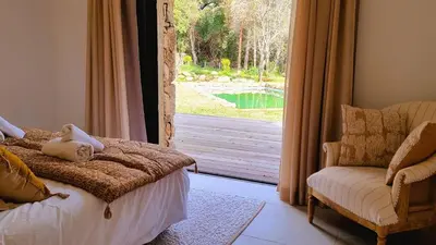 a bedroom with a bed and a view of a pool at Domaine de Gialla Bergerie I Pini, 6 pers, piscine chauffée, 10 mn plage in Arraggio