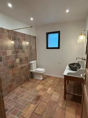 a bathroom with a toilet and a sink at Casa Scaledda in Bocognano