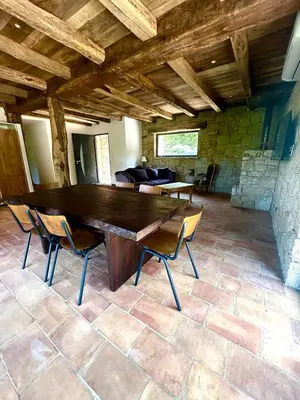 a large wooden table and chairs in a room at Casa Scaledda in Bocognano