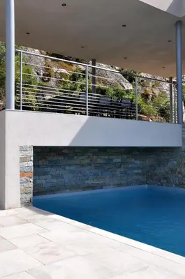a swimming pool in the middle of a house at Magnifique villa avec piscine chauffée, vue mer et montage in Porto-Vecchio