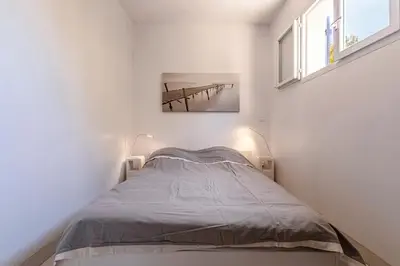 a small bedroom with a bed and a table at Casa di Ruppione - Magnifique Vue Mer in Pietrosella