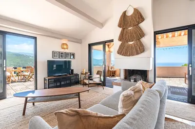 a living room with a couch and a table and a tv at Casa di Ruppione - Magnifique Vue Mer in Pietrosella