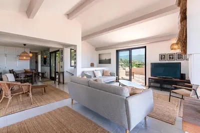 a living room with a couch and a tv at Casa di Ruppione - Magnifique Vue Mer in Pietrosella