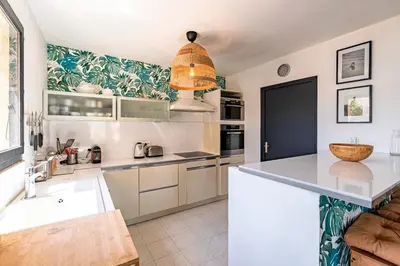a kitchen with a large island with a counter top at Casa di Ruppione - Magnifique Vue Mer in Pietrosella