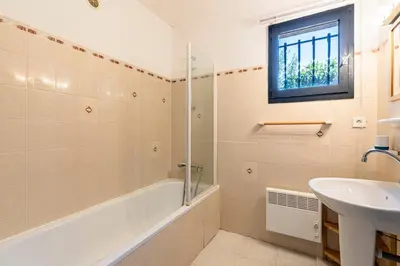 a bathroom with a tub and a sink and a shower at Casa di Ruppione - Magnifique Vue Mer in Pietrosella