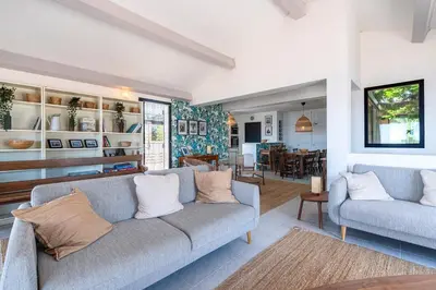 a living room with a couch and a dining room at Casa di Ruppione - Magnifique Vue Mer in Pietrosella