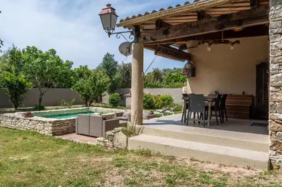 a patio with a table and a swimming pool at La bergerie 1 in Bonifacio