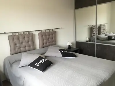 a bedroom with a large bed with two pillows on it at Locations I Carboni - villa 3 chambres in Sollacaro