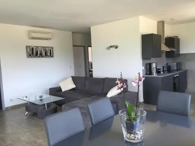 a living room with a couch and a table at Locations I Carboni - villa 3 chambres in Sollacaro