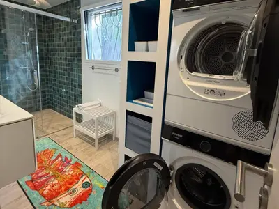 a kitchen with a washing machine in a bathroom at Vacation home near Porto Vecchio in Porto-Vecchio