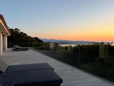 a view of the sunset from the balcony of a house at Vacation home near Porto Vecchio in Porto-Vecchio