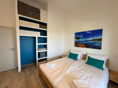 a bedroom with a large bed with green pillows at Vacation home near Porto Vecchio in Porto-Vecchio