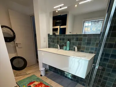 a bathroom with a sink and a glass shower at Vacation home near Porto Vecchio in Porto-Vecchio