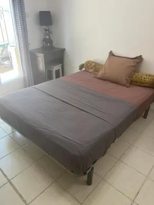 a large bed sitting in a bedroom with at Sacré cœur in Ajaccio