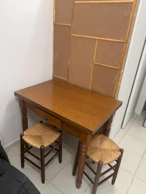 a wooden table with two stools in a room at Sacré cœur in Ajaccio