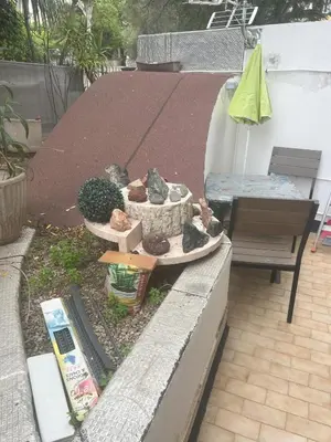 a patio with a garden with a bench and some plants at Sacré cœur in Ajaccio