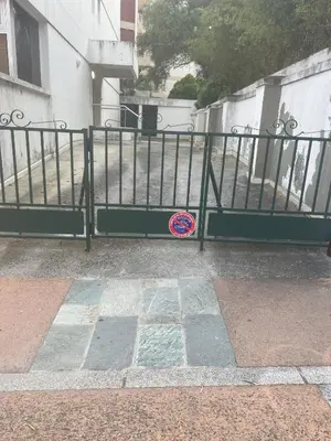 a black metal fence with a sticker on it at Sacré cœur in Ajaccio
