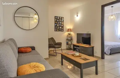 a living room with a couch and a tv at Appartement Lucciana Corse plage à 2 minutes in Lucciana