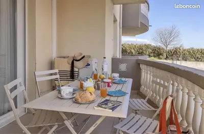 a table and chairs on a balcony with a breakfast at Appartement Lucciana Corse plage à 2 minutes in Lucciana