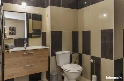 a bathroom with a toilet and a sink and a mirror at Appartement Lucciana Corse plage à 2 minutes in Lucciana