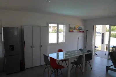 a kitchen and dining room with a table and chairs at Villa Nova in Aléria