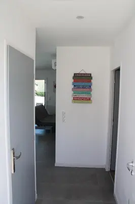 a hallway with a stack of books on the wall at Villa Nova in Aléria