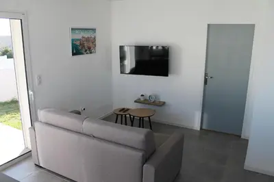 a living room with a couch and a table at Villa Nova in Aléria