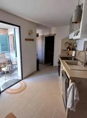 a kitchen with a sink and a counter top at Centre village, appartement en RDC in Sotta