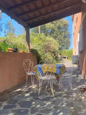 a patio with a table and chairs on a patio at Appartement T2 Alistro San Giuliano Corse in San-Giuliano