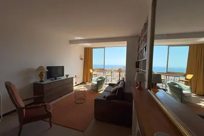a living room with a couch and a tv at Fage - Panoramic view Spacious Luminous - by TGB in Ajaccio