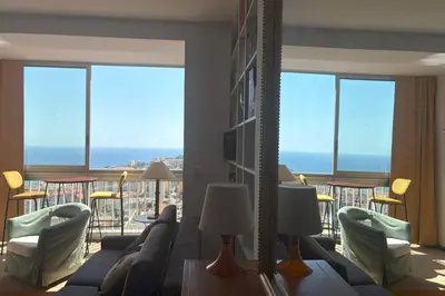 a living room with a couch and chairs and a balcony at Fage - Panoramic view Spacious Luminous - by TGB in Ajaccio