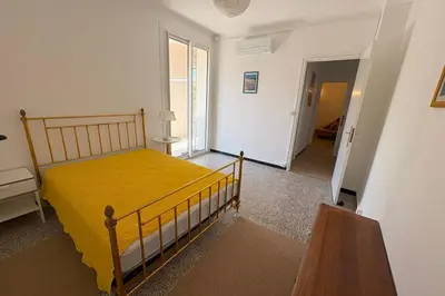 a bedroom with a bed with a yellow blanket at Fage - Panoramic view Spacious Luminous - by TGB in Ajaccio