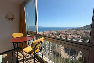 a balcony with two chairs and a table and a view at Fage - Panoramic view Spacious Luminous - by TGB in Ajaccio