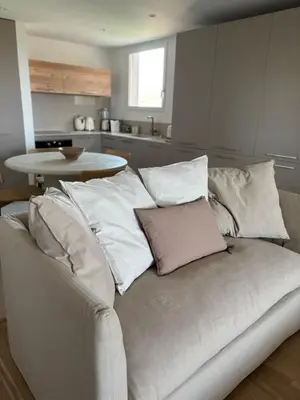 a white couch with pillows on it in a kitchen at T2 - sea and Corsican maquis in Bonifacio